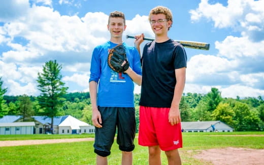 two boys holding baseball bats