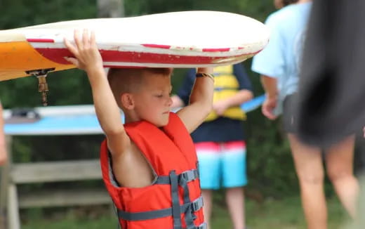 a baby holding a surfboard