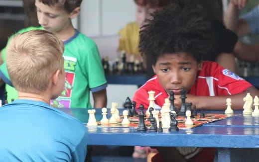 a group of boys playing chess