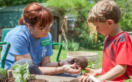 a person and a boy planting plants