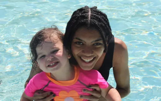 a person and a child in a pool