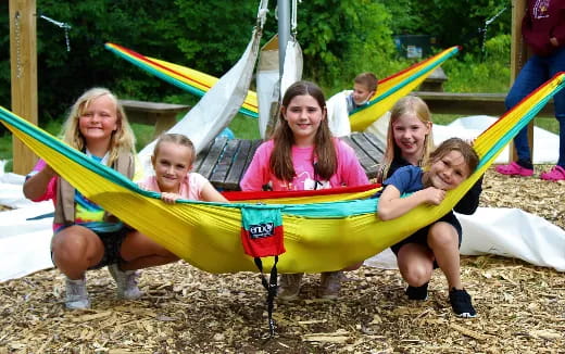 a group of girls in a hammock