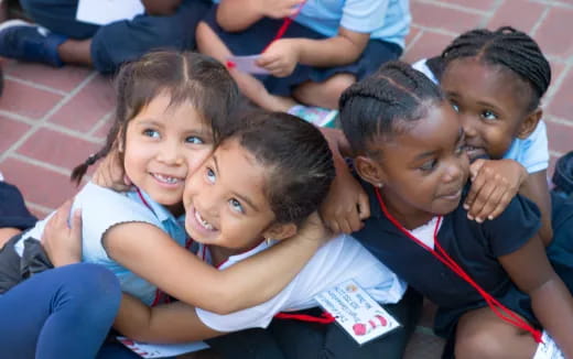 a group of children sitting on the ground
