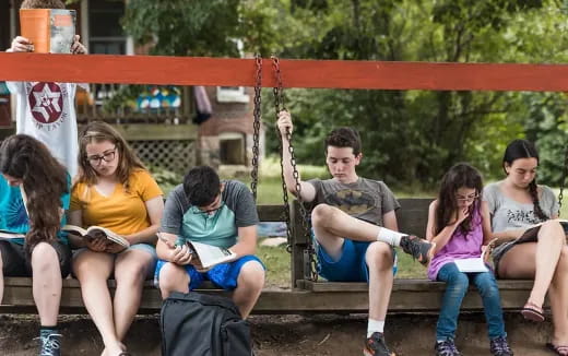 a group of people sitting on a bench