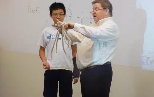 a couple of men in a classroom