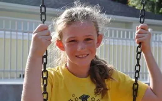 a girl holding a swing