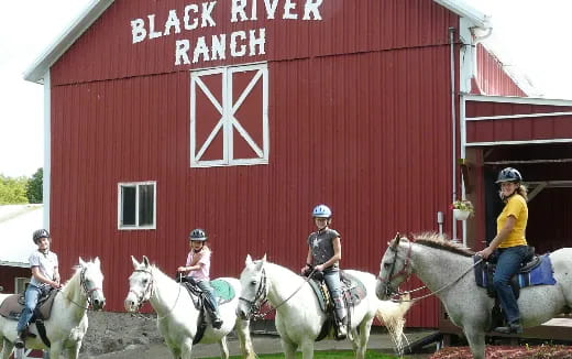 a group of people riding horses