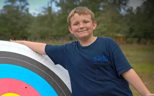 a boy holding a surfboard