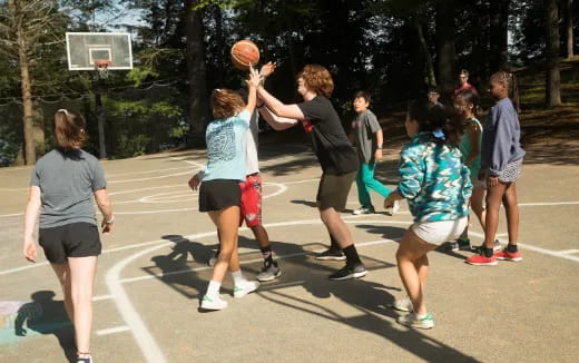 a group of people playing basketball