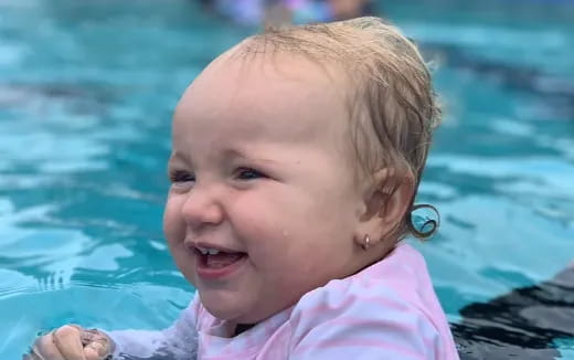 a baby in a pool