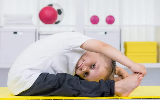 a child lying on a yellow surface