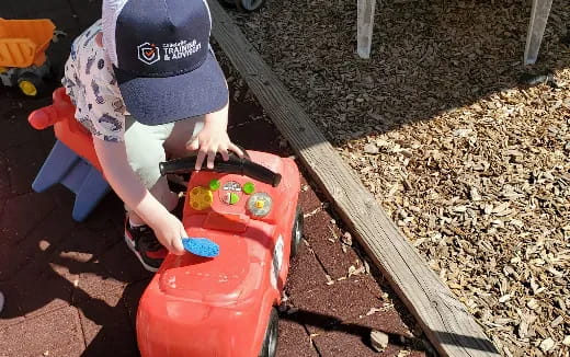 a child playing with a toy car