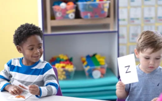 a couple of boys holding a sign