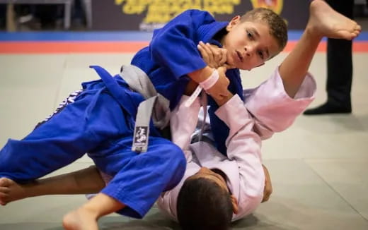 a couple of boys in karate uniforms
