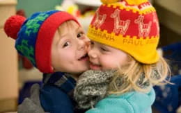a couple of children wearing hats