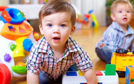 a couple of young boys playing with toys