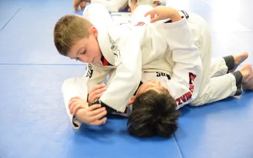 a few boys in karate uniforms