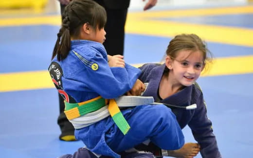 a few young girls in blue uniforms