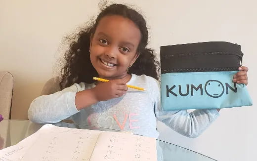 a girl holding a sign