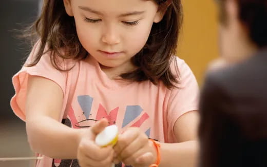 a girl holding a toy