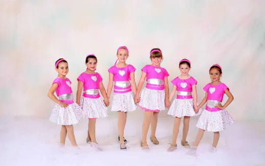 a group of girls in matching outfits