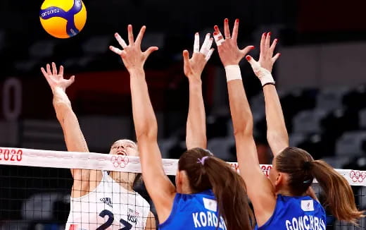 a group of girls playing volleyball
