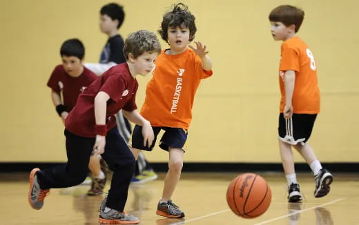 a group of kids playing basketball