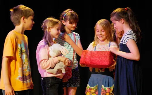 a group of people holding a stuffed animal