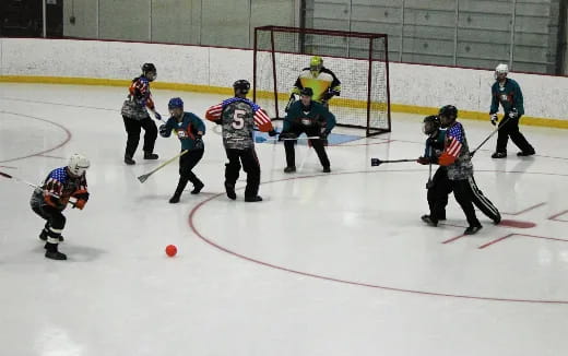 a group of people playing hockey