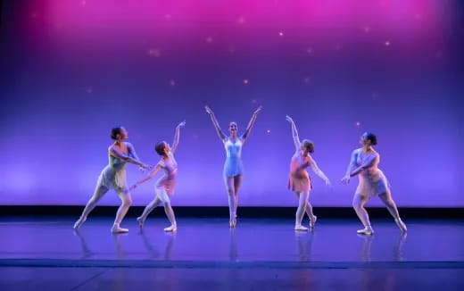 a group of women dancing on a stage