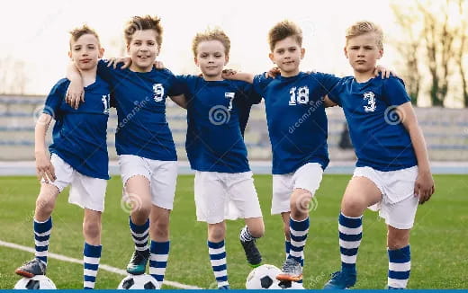 a group of young boys playing football