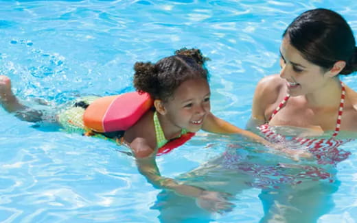 a person and a child in a pool
