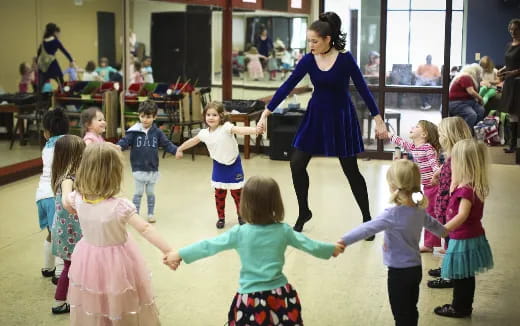 a person and children dancing