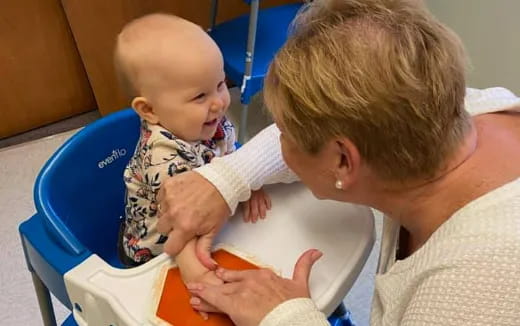 a person feeding a baby