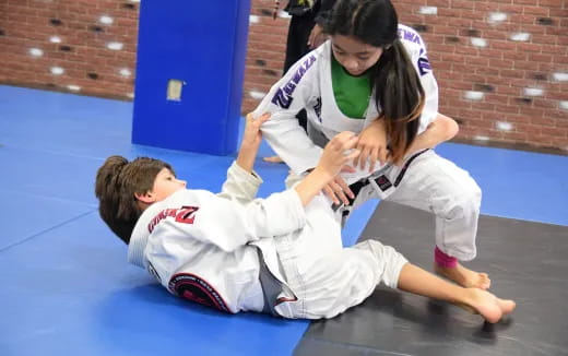 a person helping a boy do karate
