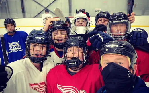 hockey players holding sticks