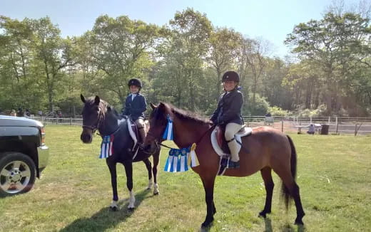 two people riding horses