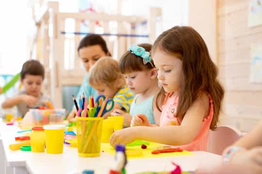 a group of children sitting at a table