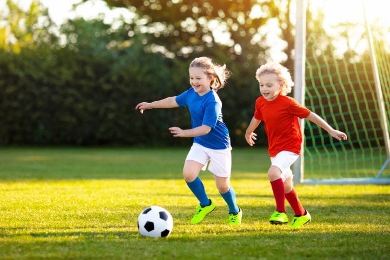 a couple of young girls playing football