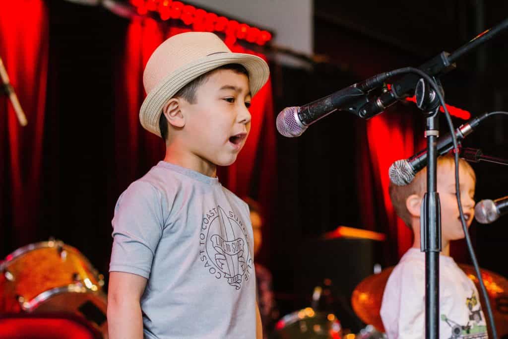 a boy singing into a microphone