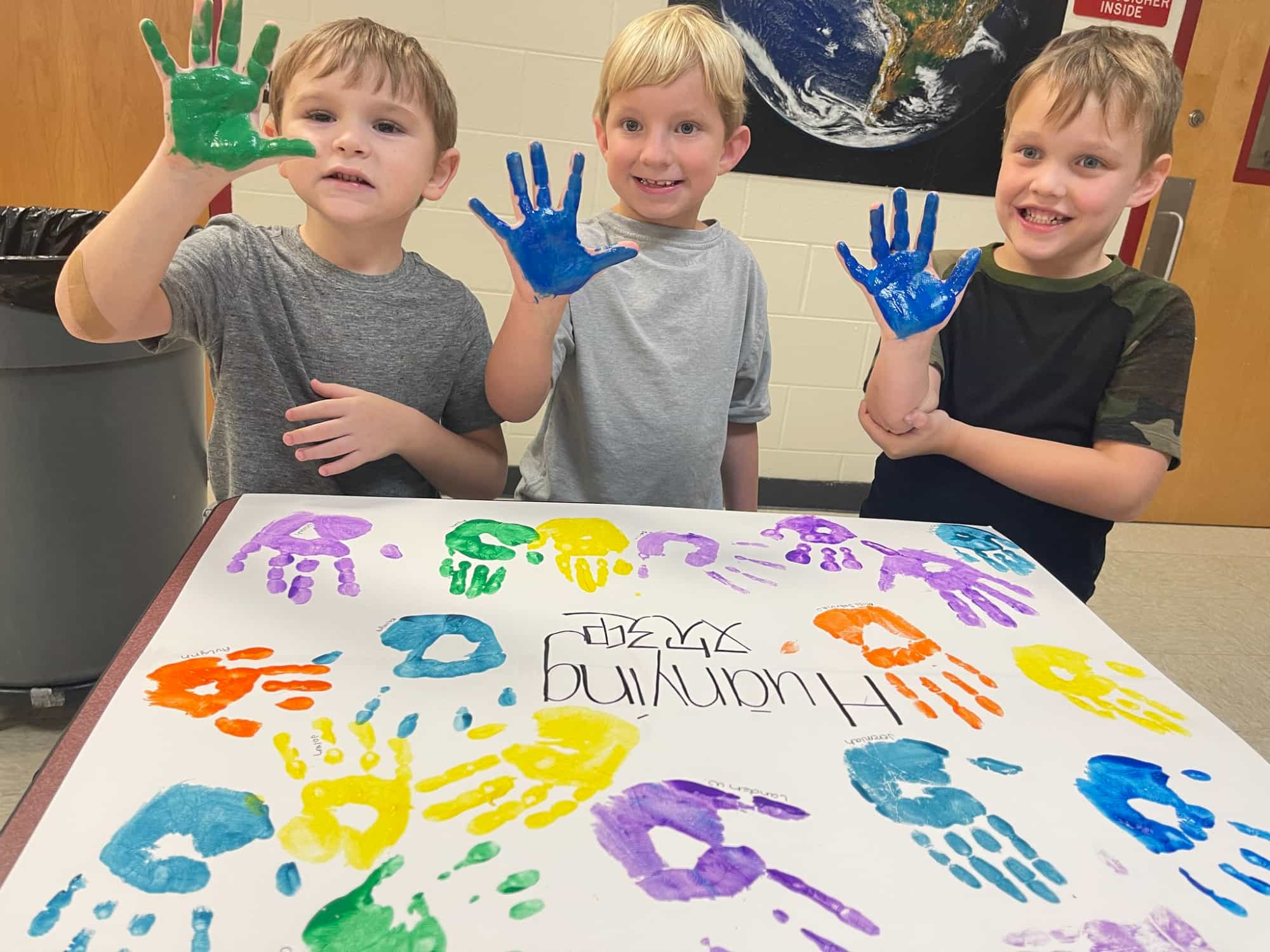 a group of boys posing for a picture with a birthday cake