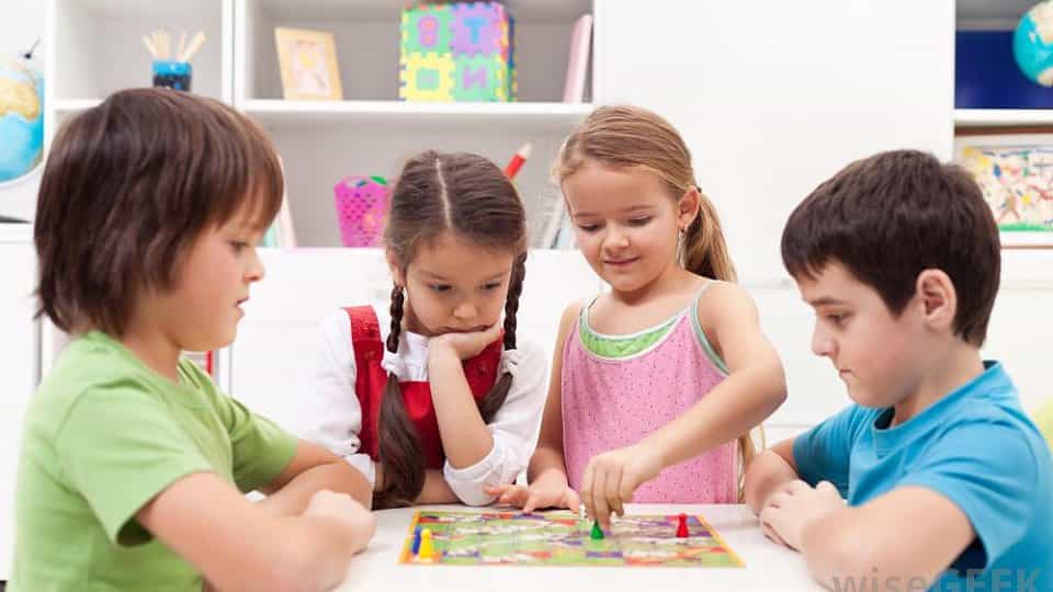 a group of children sitting at a table